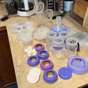 Collection of pump parts and breastfeeding supplies.